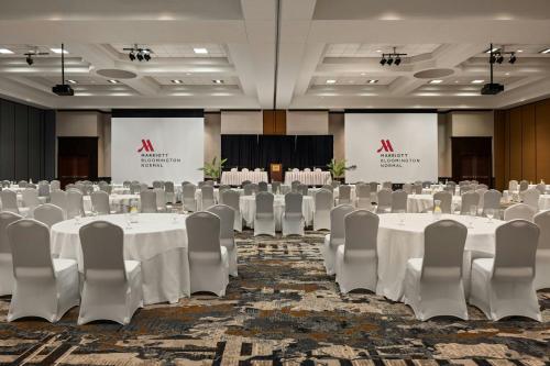 a conference room with white tables and chairs at Marriott Bloomington Normal Hotel and Conference Center in Bloomington