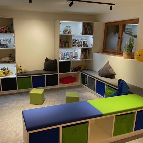 a childs room with a table and chairs at activechalets six.nine.eight in Reit im Winkl
