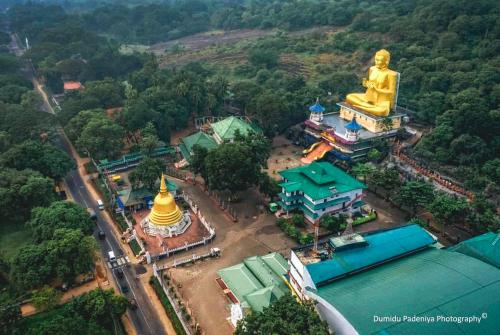 an aerial view of a large statue of a giant buddha at Golden stars hotel Dambulla in Dambulla