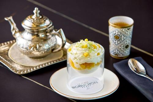 a dessert in a glass on a plate with a cup of coffee at Rabat Marriott Hotel in Rabat