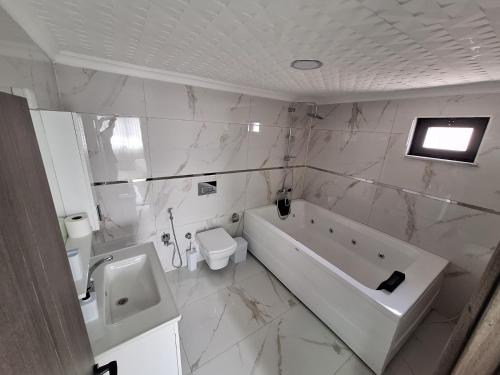 a bathroom with a tub and a toilet and a sink at Daly Resort 2 in Sapanca
