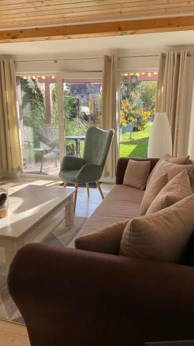 a living room with a couch and a chair at Harzer Ferienlodge in Wernigerode