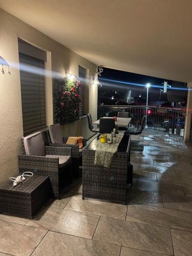 a room with couches and tables and a balcony at night at Fantastic villa in Fischamend in Fischamend Dorf