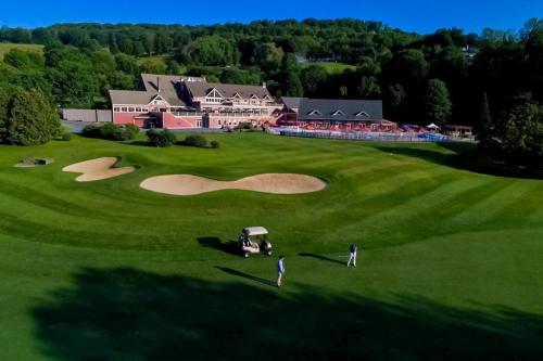 an aerial view of a golf course with a house at Sky Full Of Wishes in Quechee