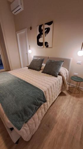 a bedroom with a large bed with two pillows at Ta-49 bed e breakfast in Naples
