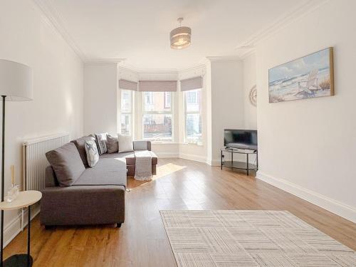a living room with a couch and a television at Crown road in Great Yarmouth