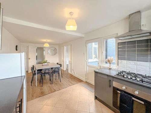 a kitchen and dining room with a table and a refrigerator at Crown road in Great Yarmouth