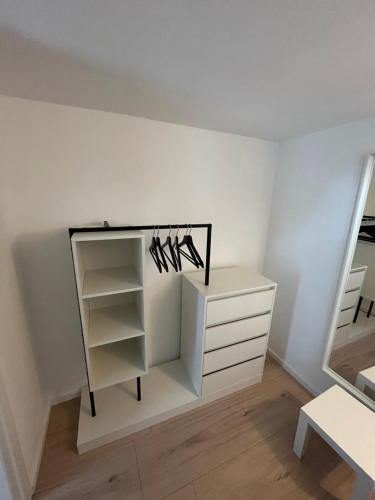 a room with a closet with shoes on a shelf at Meeresrauschen - Strandnah und ruhig in Scharbeutz