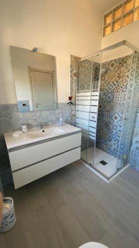 a bathroom with a sink and a shower at Quiet House - appartamento Maestrale in Porto Torres
