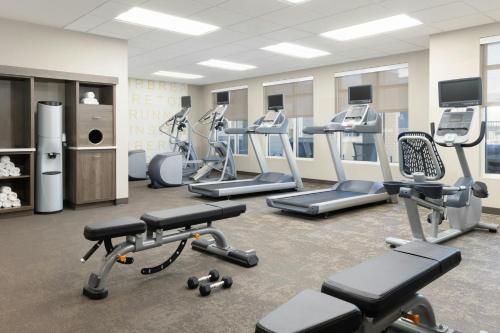 a gym with several treadmills and cardio machines at Residence Inn by Marriott Denver Central Park in Denver
