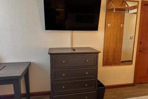 a dresser in a room with a table and a mirror at Everline #350 in Olympic Valley