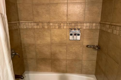 a bathroom with a shower with a tub and a sink at Everline #350 in Olympic Valley