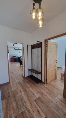 an open living room with wooden floors and a chandelier at Chill out Zone , villa with 4 bedrooms, whole apartment, апартамент целиком in Dilijan