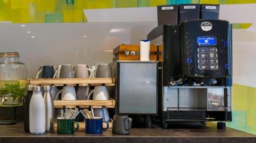 a coffee maker sitting on top of a counter at Holiday Inn - the niu, Ridge Halle Central Station by IHG in Halle an der Saale