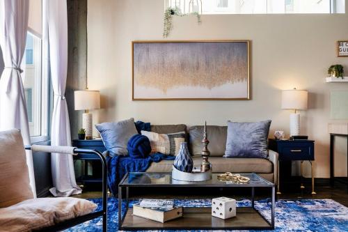 a living room with a couch and a table at Chic Downtown Industrial loft in Dallas