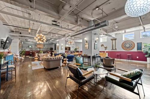 a living room with a lot of chairs and tables at Chic Downtown Industrial loft in Dallas