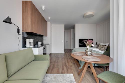 a living room with a couch and a table at Scala City Center Premium Apartments with Parking by Lion Apartments in Gdańsk