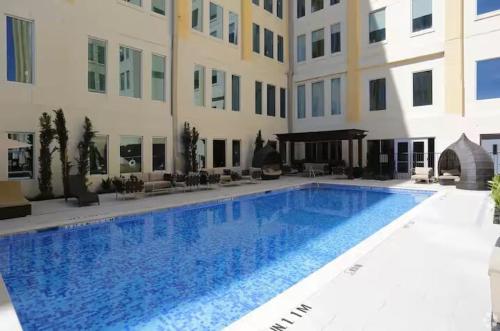 a large swimming pool in front of a building at Chic Downtown Industrial loft in Dallas