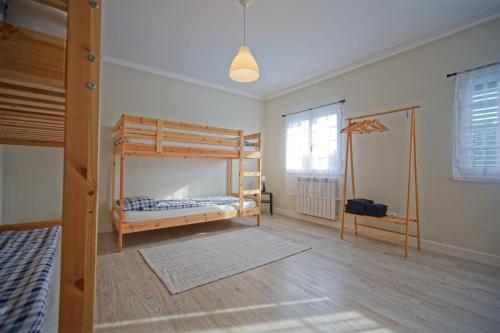 a bedroom with two bunk beds and a window at Villa As Cumadres in Azeitao