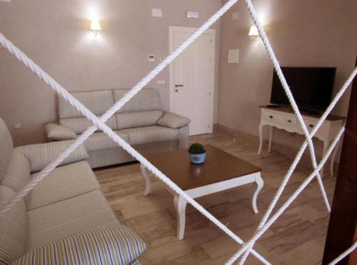 a living room with a couch and a table at Suites BELLAHELLIN in Hellín