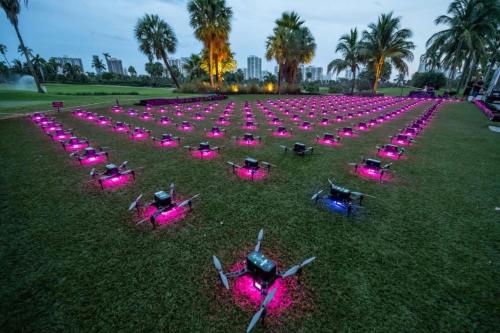 a group of people laying in the grass with pink lights at JW Marriott Miami Turnberry Resort & Spa in Aventura
