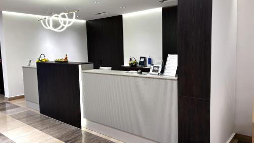 a lobby with a reception desk with a counter at Hotel Park in Našice