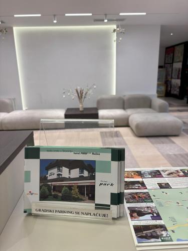 a book on a table in a living room at Hotel Park in Našice