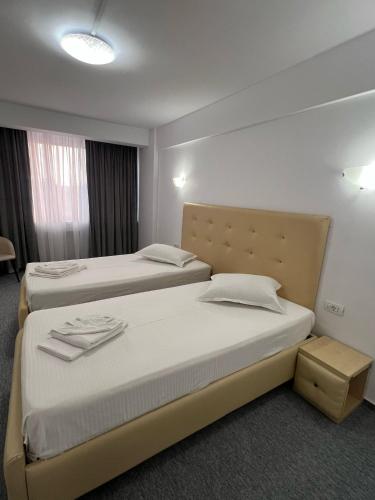 a hotel room with two beds in a room at Hotel viilor in Bucharest