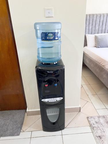 a water cooler with a container on top of it at Caramel Home in Mombasa