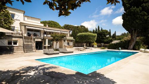 une piscine devant une maison dans l'établissement Magnifique Villa en bord de mer, à Sanary-sur-Mer
