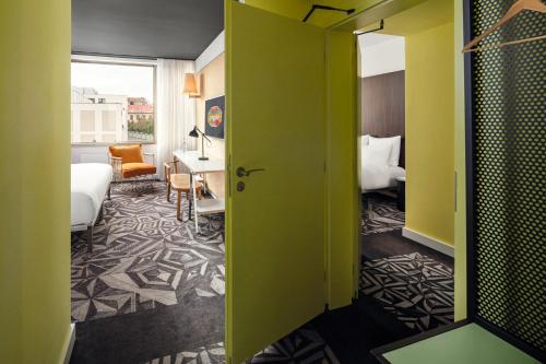 a room with a bed and a room with a desk at Mama Shelter Prague in Prague