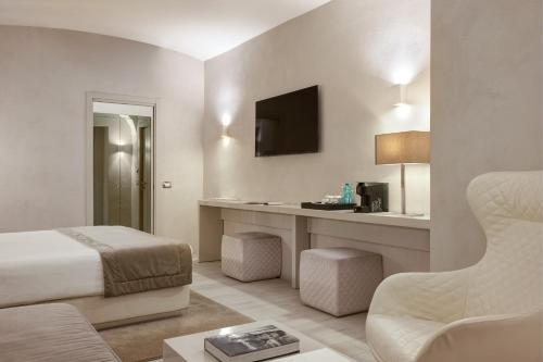 a hotel room with a bed and a desk at Terrace Pantheon Relais in Rome
