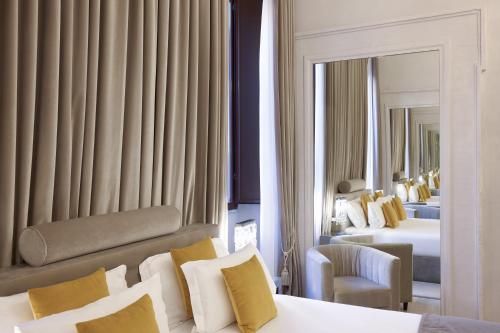 a hotel room with two beds and a mirror at Terrace Pantheon Relais in Rome