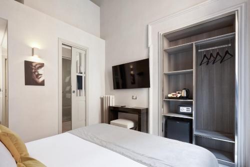 a bedroom with a white bed and a desk at Terrace Pantheon Relais in Rome