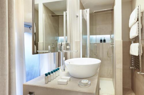 a bathroom with a white sink and a shower at Terrace Pantheon Relais in Rome