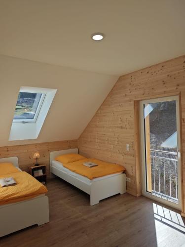 a bedroom with two beds and a window at Ferienhaus Haselnuss in Schleiden