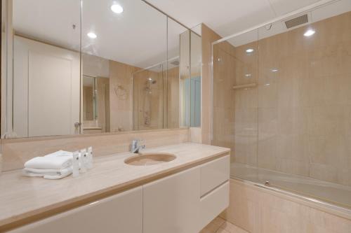 a bathroom with a sink and a shower at Stylish 1BR Beachside Escape - Heart of Gold Coast in Gold Coast