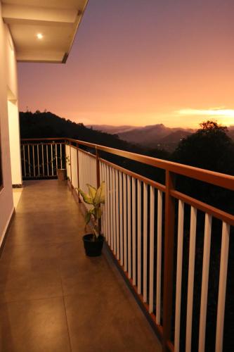 a balcony with a view of the mountains at Asprin Homestay in Munnar