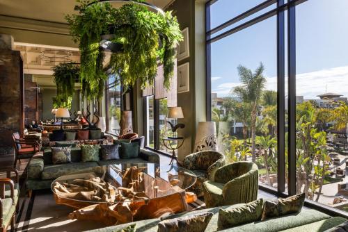a lobby with couches and a large window at Hotel Riu Palace Tikida Agadir - All Inclusive in Agadir