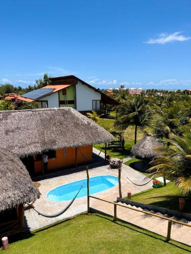 a villa with a swimming pool and a resort at Pousada Theodora in Macapá