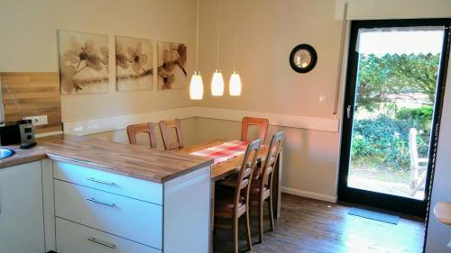 a kitchen with a table and chairs and a dining room at Haus Oldenburg "unten" in Borkum