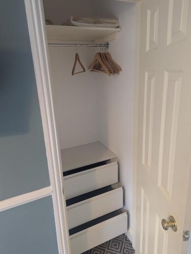 a closet with a white door and some stairs at Willowbank House in Enniskillen