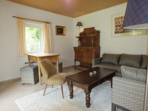 a living room with a couch and a table at Ferienhaus Nicklas in Bad Schandau
