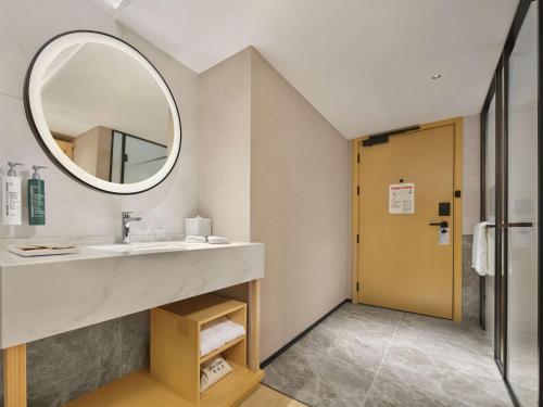 a bathroom with a sink and a mirror at Hilton Garden Inn Chengdu Tianfu Panda Tower in Chengdu
