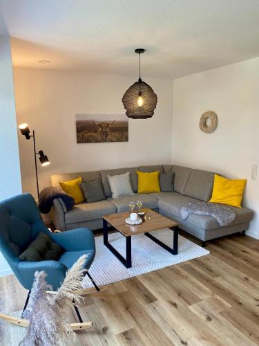 a living room with a couch and a table at MeerZeit 20 in Wittmund