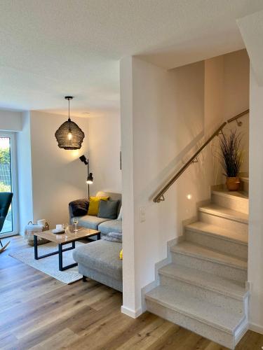 a living room with stairs and a couch at MeerZeit 20 in Wittmund