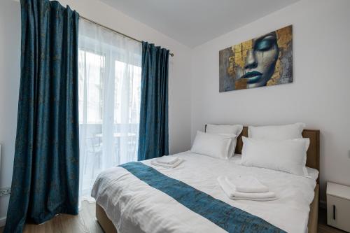 a bedroom with a bed with a large window at GPM Home and Stay Apartments in Cluj-Napoca