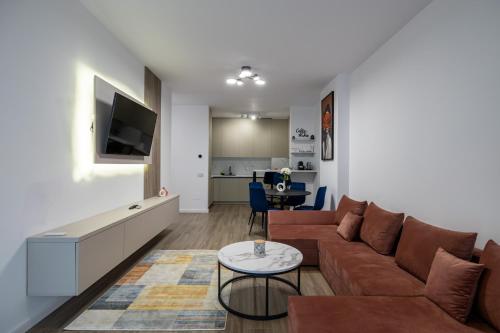 a living room with a couch and a table at GPM Home and Stay Apartments in Cluj-Napoca