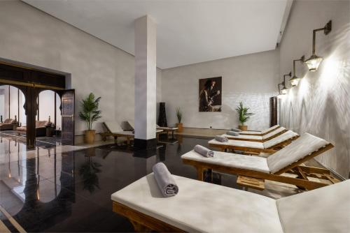 a lobby with tables and chairs in a building at Hotel Riu Palace Tikida Agadir - All Inclusive in Agadir