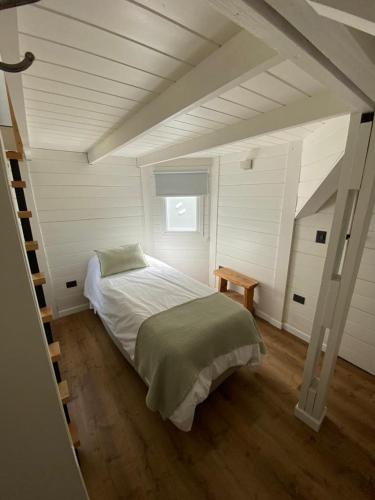 a bedroom with a bed in a attic at Casa Torre VLA in Villa La Angostura